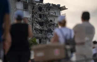 People watch the partially collapsed Champlain Towers in Surfside, Florida, north of Miami Beach. Fernando Medina/Shutterstock